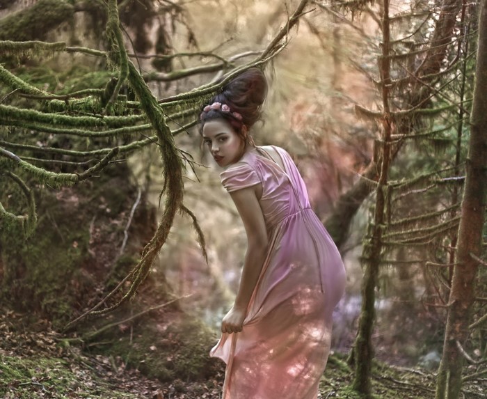 Woman in pink dress in a mossy forest