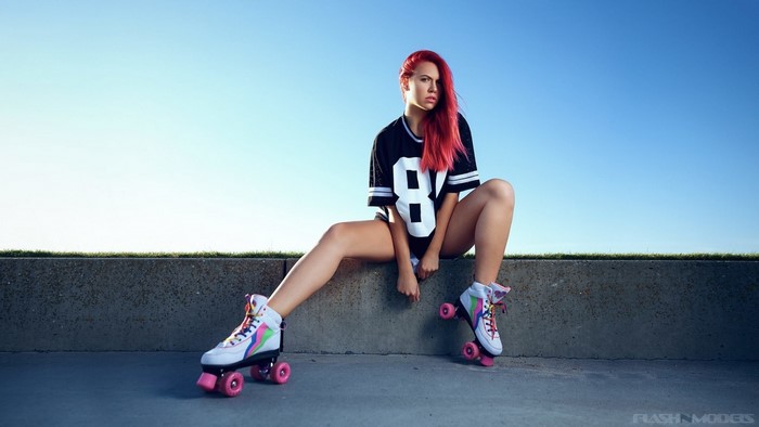 Redhead woman wearing roller skates and a jersey