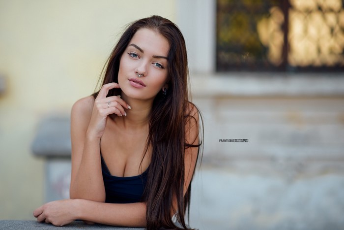 Woman with long brown hair and nose ring