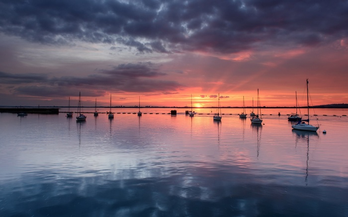 Sailboats on the water at sunset