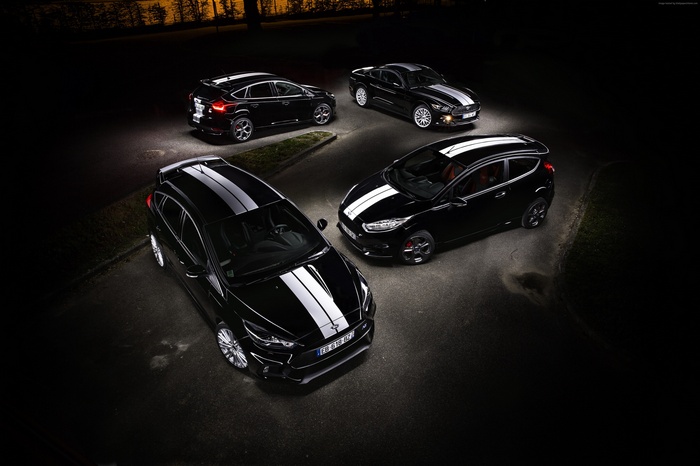 Four black Ford cars with white racing stripes