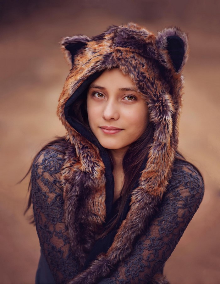 Woman wearing a furry hood with ears and lace top