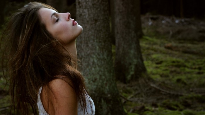 Woman with brown hair in a forest