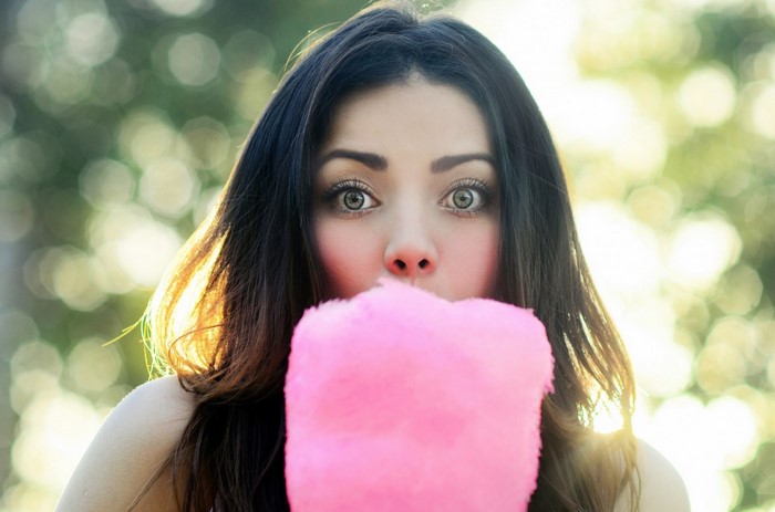 Woman eating pink cotton candy