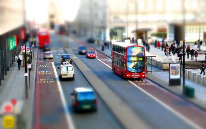 London street with red double-decker bus and pedestrians