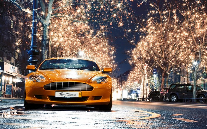 Orange Aston Martin DBS Coupe on a Wet Street at Night