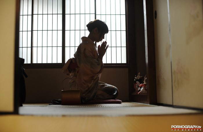 Woman in Kimono Praying in Traditional Japanese Room