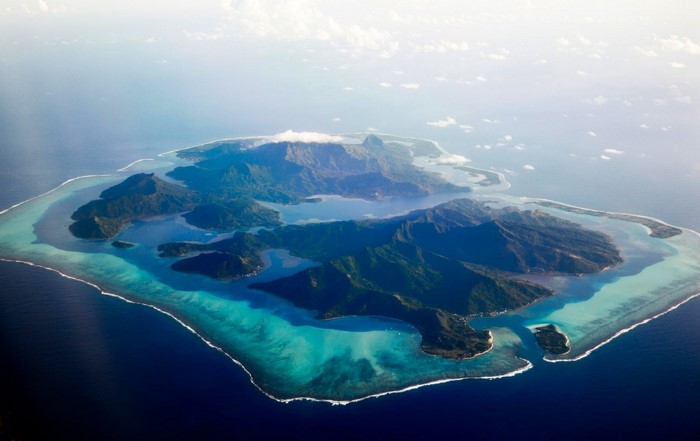 Aerial view of a tropical island with mountains and a lagoon