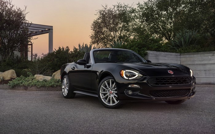 Black Fiat 124 Spider convertible parked outdoors