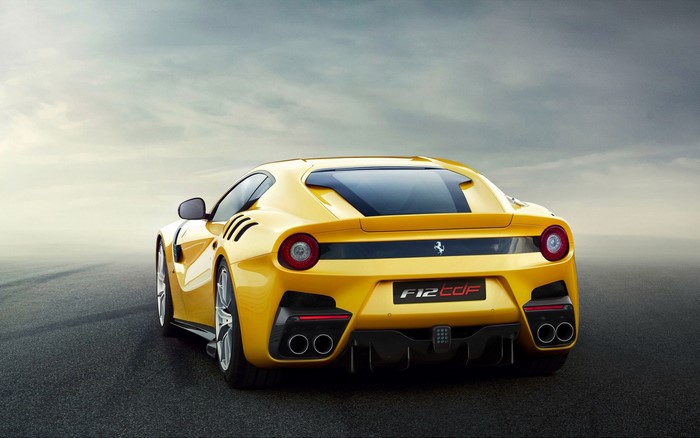 Yellow Ferrari F12 TDF parked on asphalt