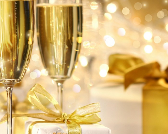 Champagne glasses and gifts with bokeh lights