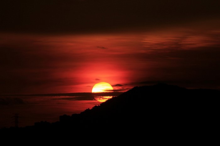 Sunset over a silhouetted mountain range