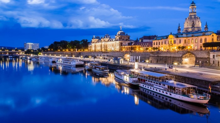 Dresden cityscape with Elbe river and boats at dusk