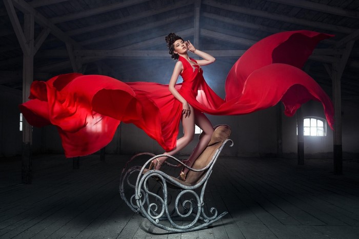 Woman in red dress on rocking chair
