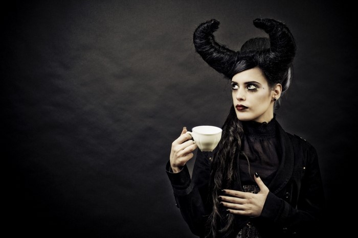 Woman with horns holding a teacup