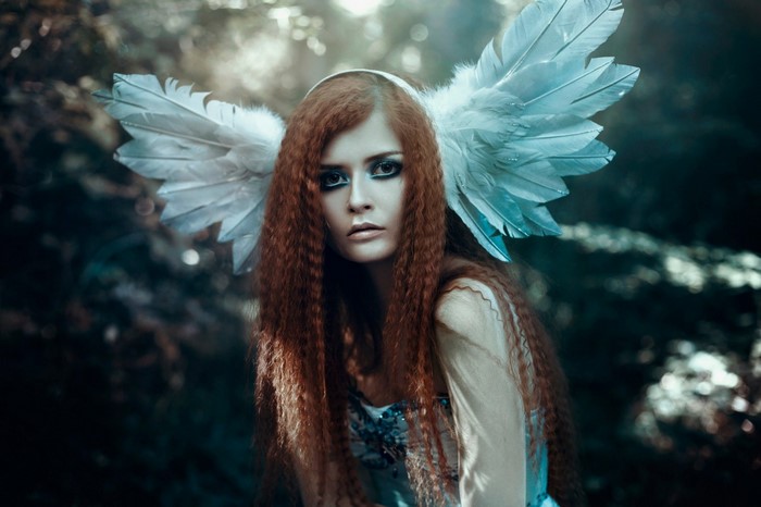 Woman with red hair and angel wings