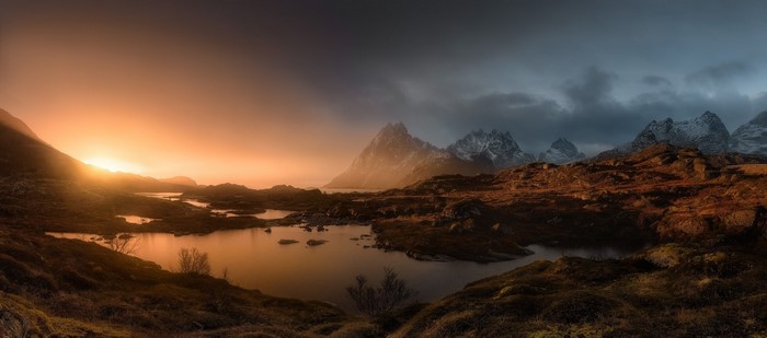 Sunset Over Misty Mountains and Lake in Lofoten Islands Norway