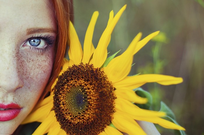 Redhead Woman with Blue Eyes and Sunflower