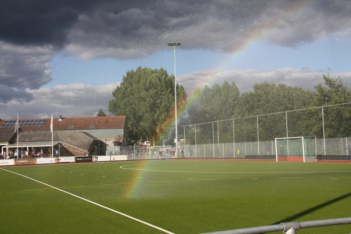 Field hockey field with rainbow and stadium