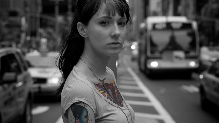 Woman with tattoos in a city street