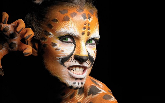 Woman with cheetah face and body paint