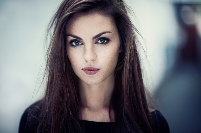 Woman with long brown hair and freckles