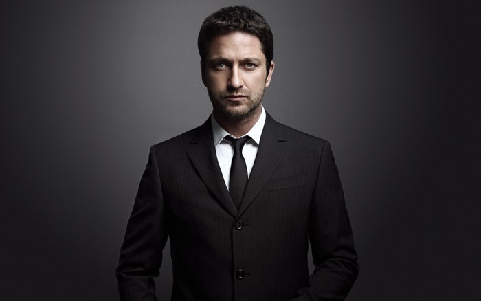 Gerard Butler wearing a black suit and tie