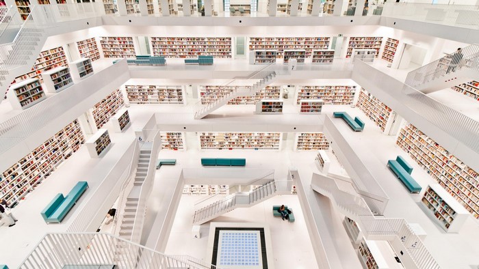 Interior of a modern library with white architecture and bookshelves