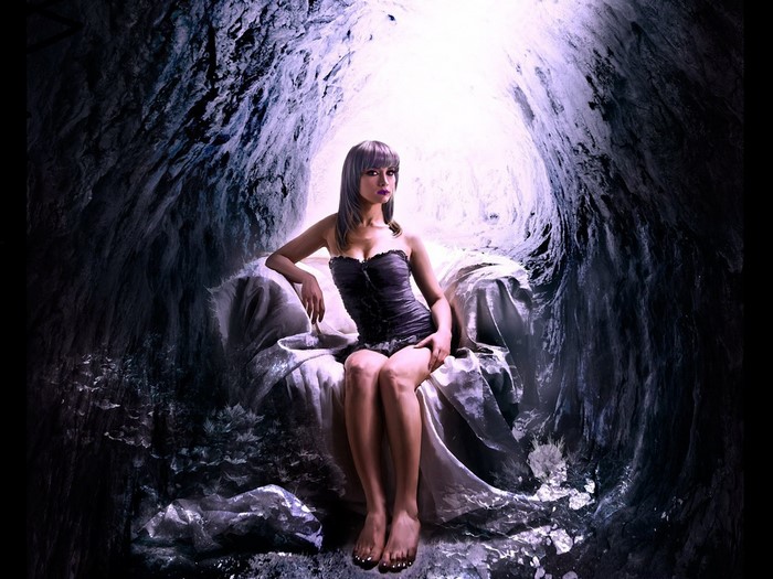 Woman sitting on a throne in a cave