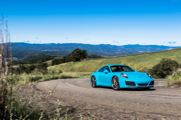 Blue Porsche 911 Carrera 4S Coupe on a winding road