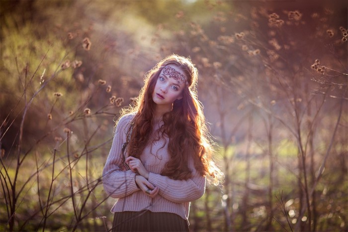 Woman with long red hair in a forest