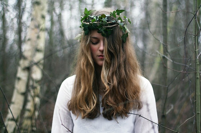 Woman with ivy crown in a forest