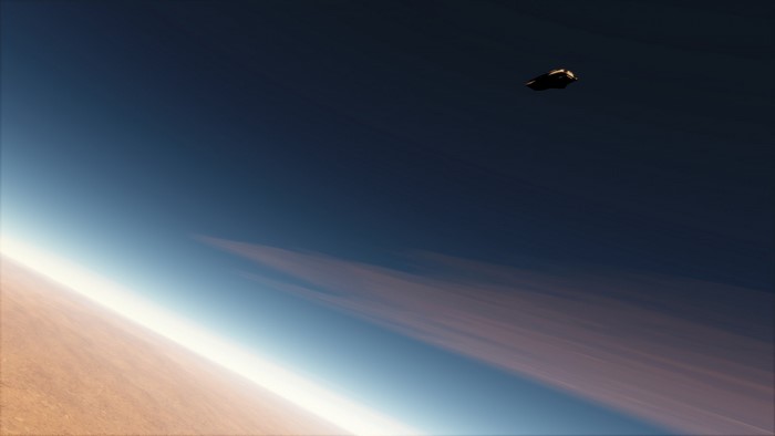 Spacecraft flying above Earth's atmosphere at sunrise