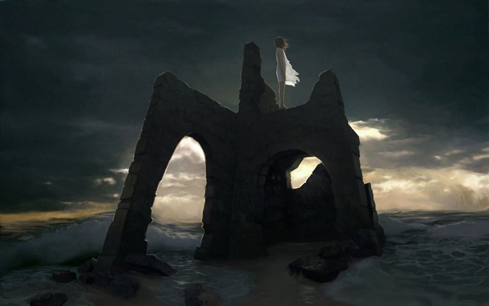 Girl in white dress on ancient ruins by the sea