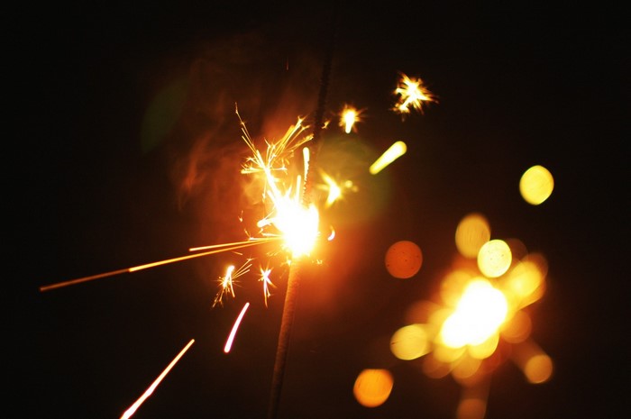 Sparkler at night with bokeh lights