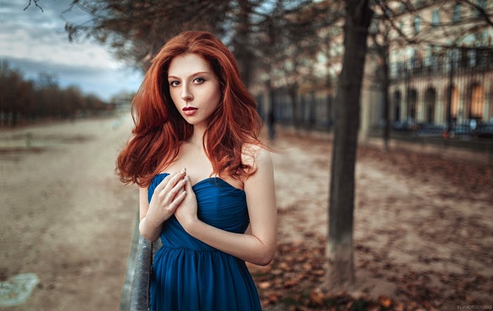 Woman with long red hair in a blue dress