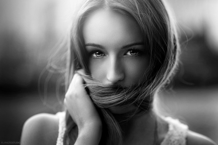 Monochrome portrait of a woman with hair covering her face