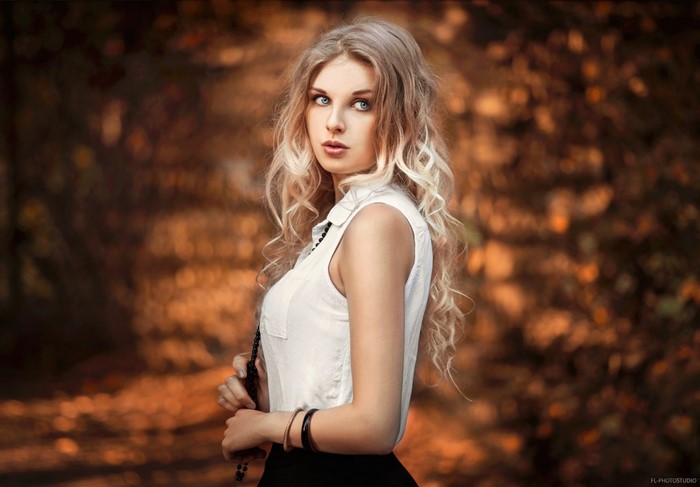 Woman with long blonde hair in a white shirt