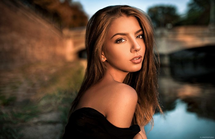 Woman with long brown hair in black top