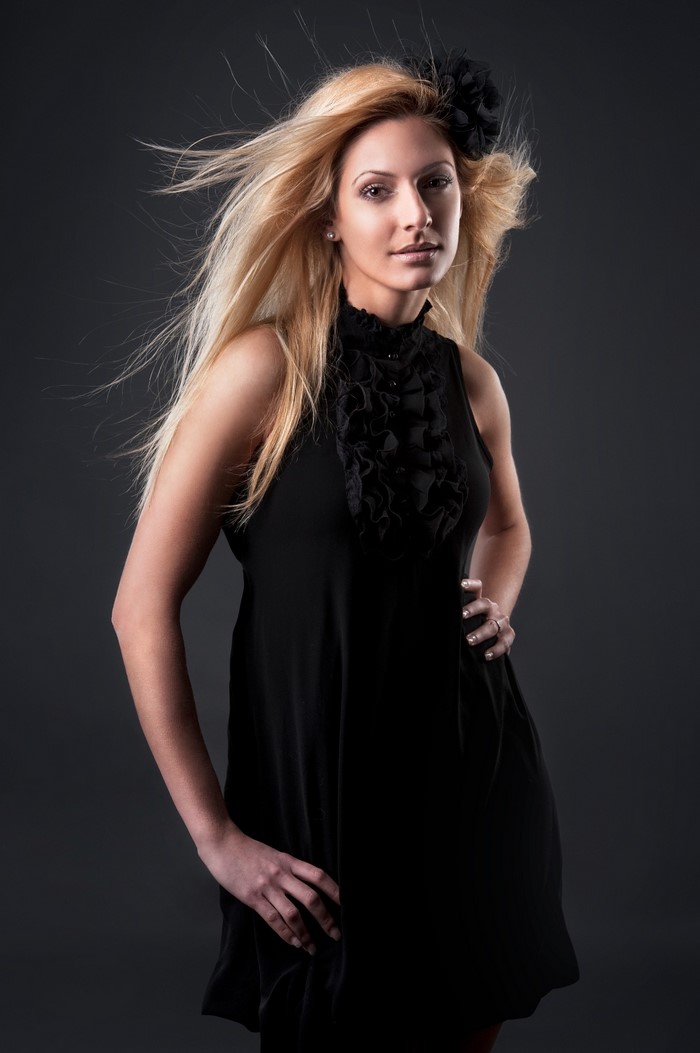 Woman in black dress with flower in hair