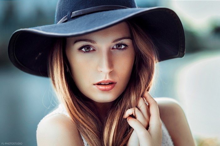 Woman wearing a wide-brimmed hat in a close-up portrait