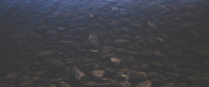 Underwater rocks with sunlight reflection