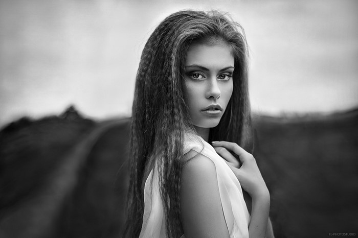 Monochrome portrait of a woman with long crimped hair