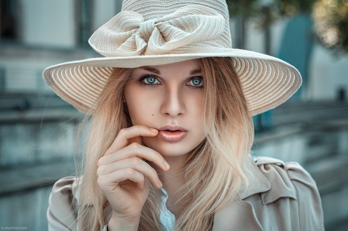Woman wearing a wide-brimmed hat and trench coat