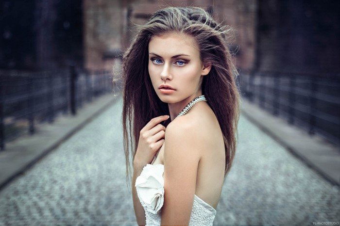 Woman with long brown hair and blue eyes
