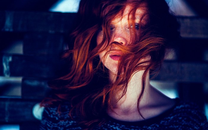 Redhead woman with hair covering her face