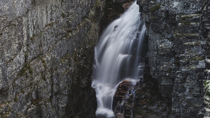 Waterfall cascading between rocky cliffs