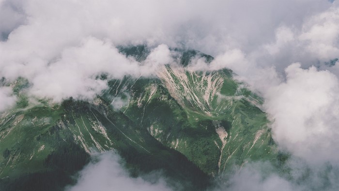 Misty mountain range with green slopes