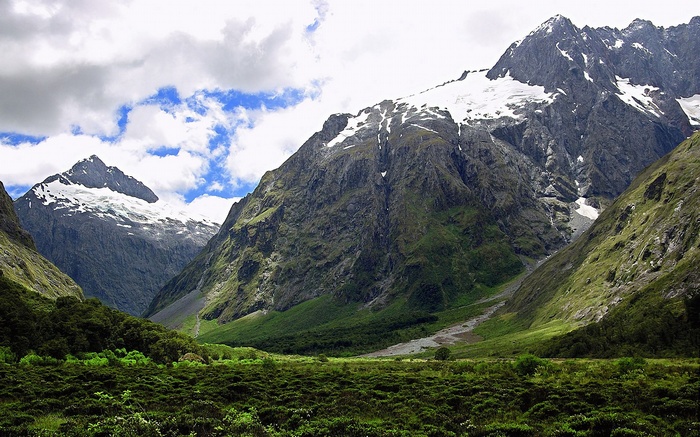 Snow-capped mountains and a green valley