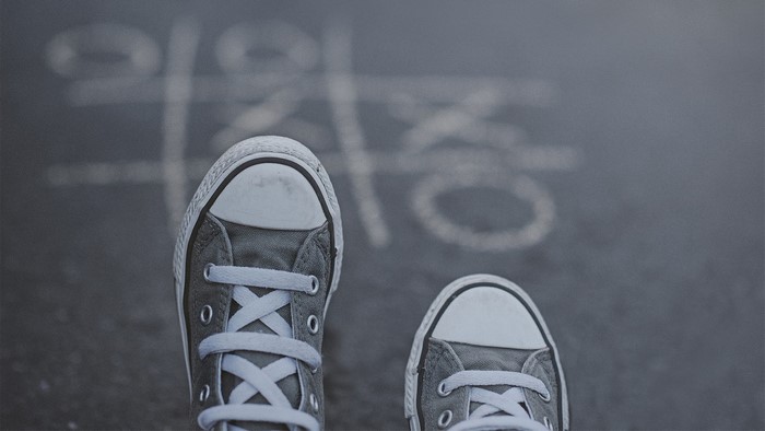 Pair of Converse shoes on tic-tac-toe board